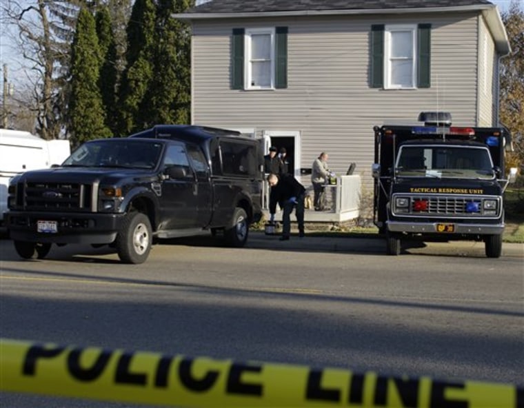 Officials process evidence at the residence of 30-year-old Matthew Hoffman, who has been arrested for kidnapping in Mount Vernon, Ohio. 